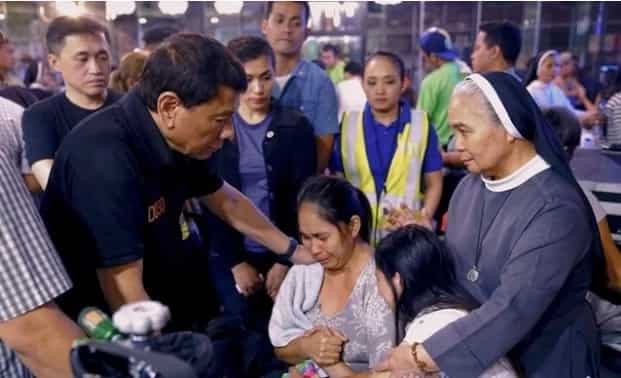 President Duterte comforts the kin of Davao Mall fire victims and even cries with them