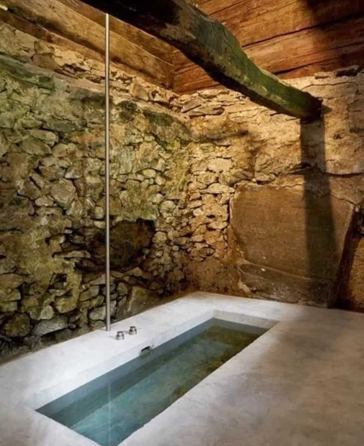 A sunken bath in what would appear an ancient shelter