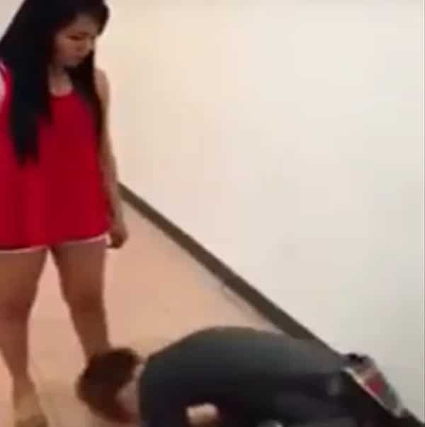 Furious girl violently kicks and punches her miserable boyfriend. He begs her to stop.