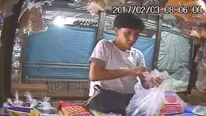 Act of stealing by an old woman who keeps on talking in order to distract the seller caught on CCTV