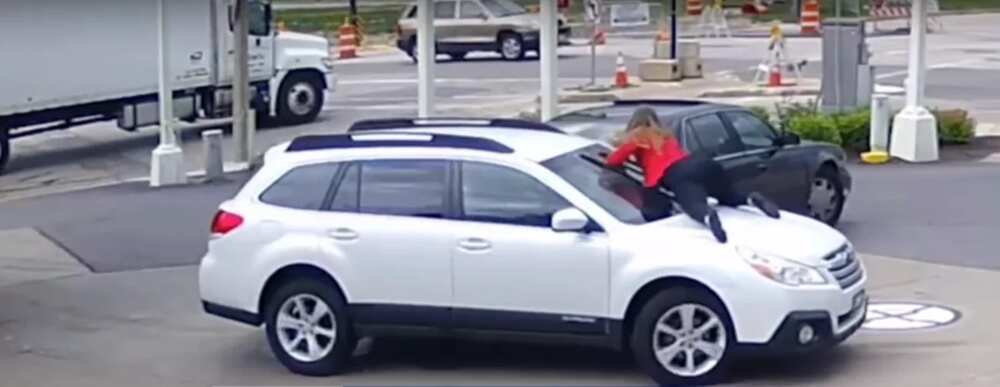 Woman stops car thief from driving away with her vehicle. She jumped on the hood unwilling to let go of her car...