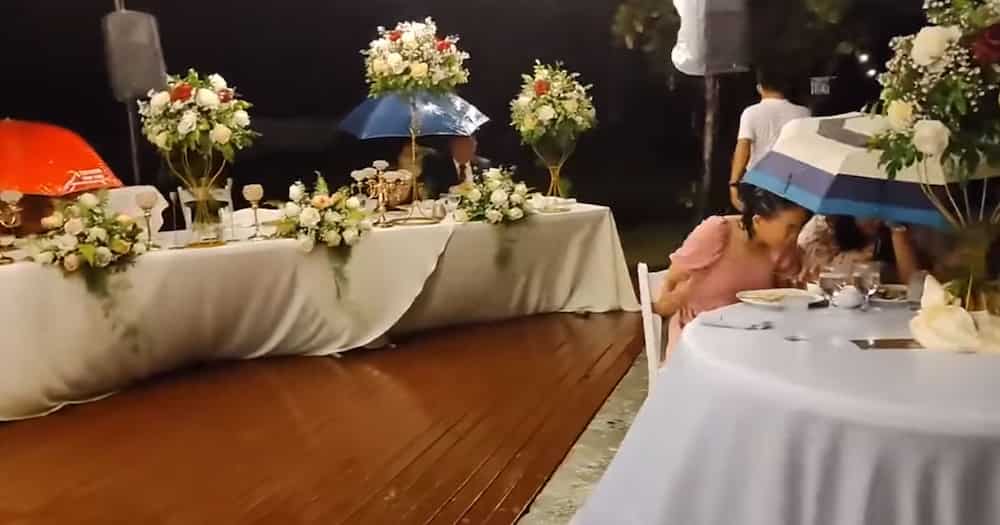 Video ng maulan na wedding reception sa Cebu, viral; Mga guests, tuloy lang sa pagkain kahit basang-basa na