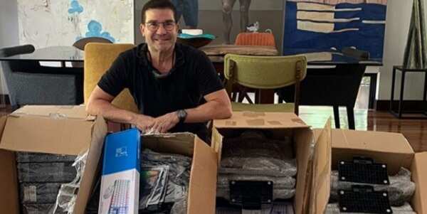 Edu Manzano helps provide computers to poor students in need