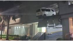 Puting van, lumusot mula sa 2nd-level parking area ng 1 gusali sa Cebu