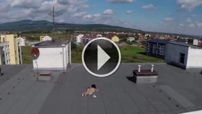 FUNNY: Topless girl is spotted on a roof by a man through his drone. What she does to the robot is hilarious!